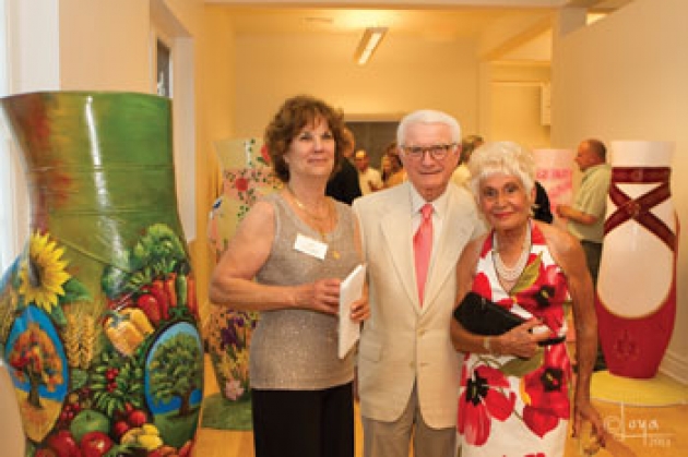 Sponsors Neil and Jane Golub, joined by museum director Donna Skiff (left) with “Dreams of Folly,” created by David Farnsworth Globerson. Photo courtesy of Tammy Loya.