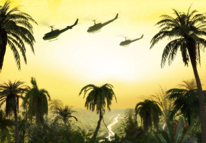 American Huey military helicopter formation flying over the jungle at sunset during the Vietnam War.