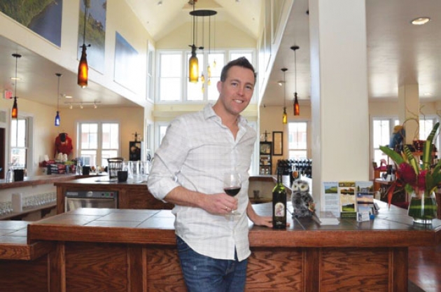 Josh Cupp poses inside the wine tasting room of Thirsty Owl Outlet &amp; Wine Garden, at the corner of Broadway and Lincoln in Saratoga Springs. Photo courtesy of Deborah Neary.
