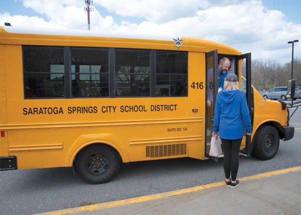 Photo of a Saratoga Springs City School District school bus by Super Source Media Studios.
