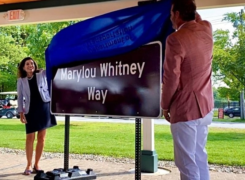 NY Gov. Kathy Hochul and John Hendrickson on the backstretch at Saratoga on Aug. 26, 2022, unveiling a road sign dedicated in the memory of Marylou Whitney. Photo by Thomas Dimopoulos. 