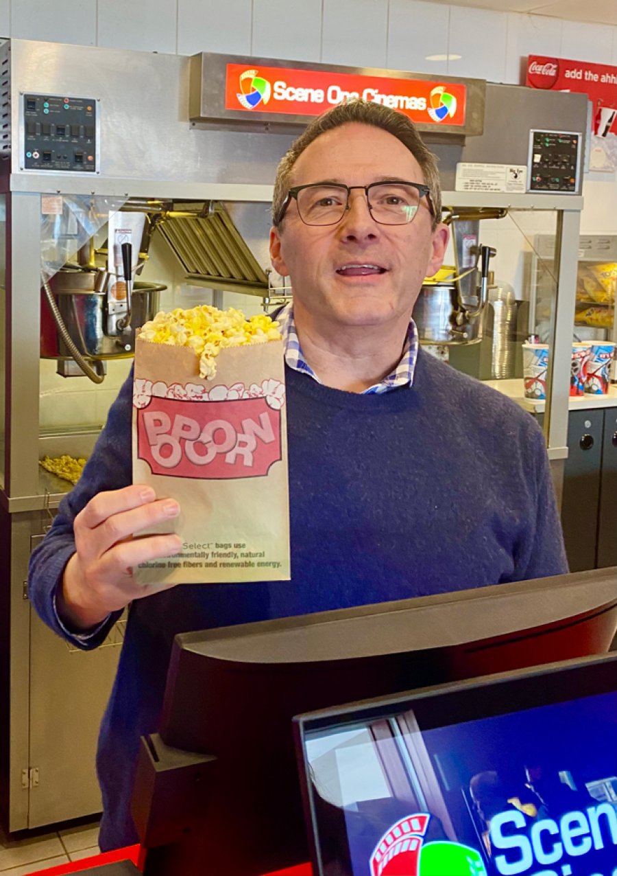 Joe Masher, owner and CEO at Scene One Entertainment, with hot buttered popcorn at Wilton on March 13, 2024. Photo by Thomas Dimopoulos. 