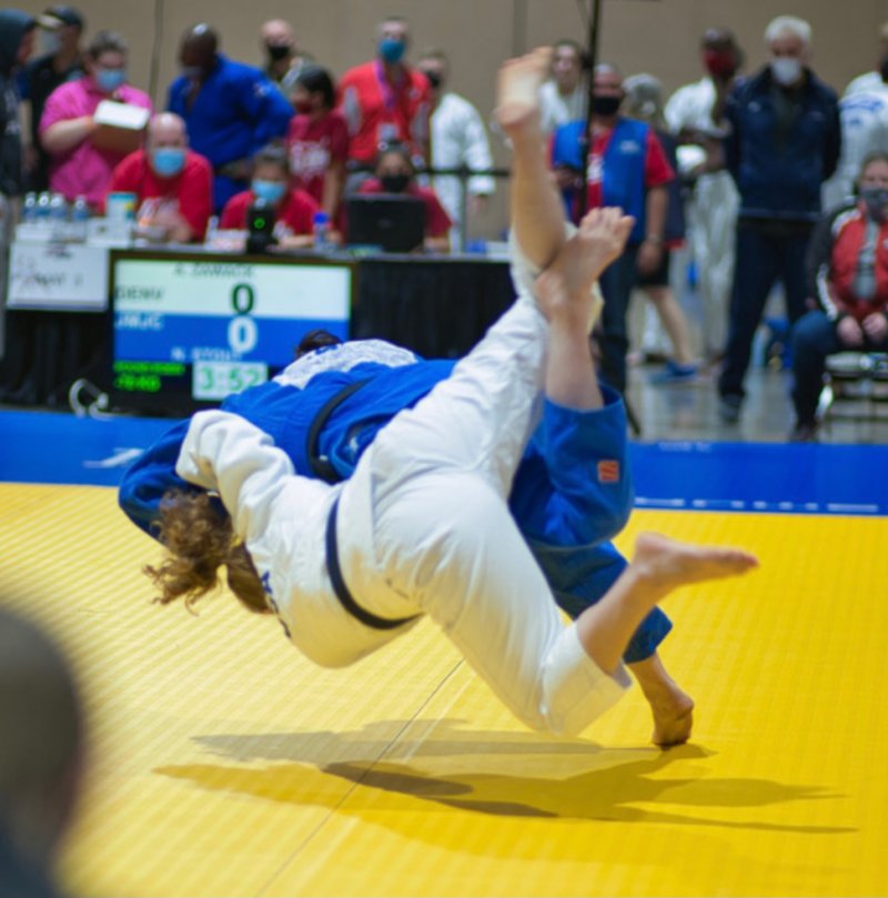 Nicole Stout (blue) throwing her opponent for the title. Photo by Merry Alaynick.