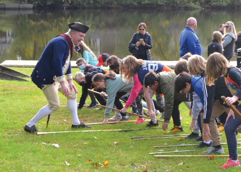 Photo: Sean Kelleher, historian of the town of Saratoga, leads Schuylerville Central School District students in a re-enactment of the grounding of arms at Fort Hardy Park on Oct. 18, 2021. Photo by SuperSource Media. 