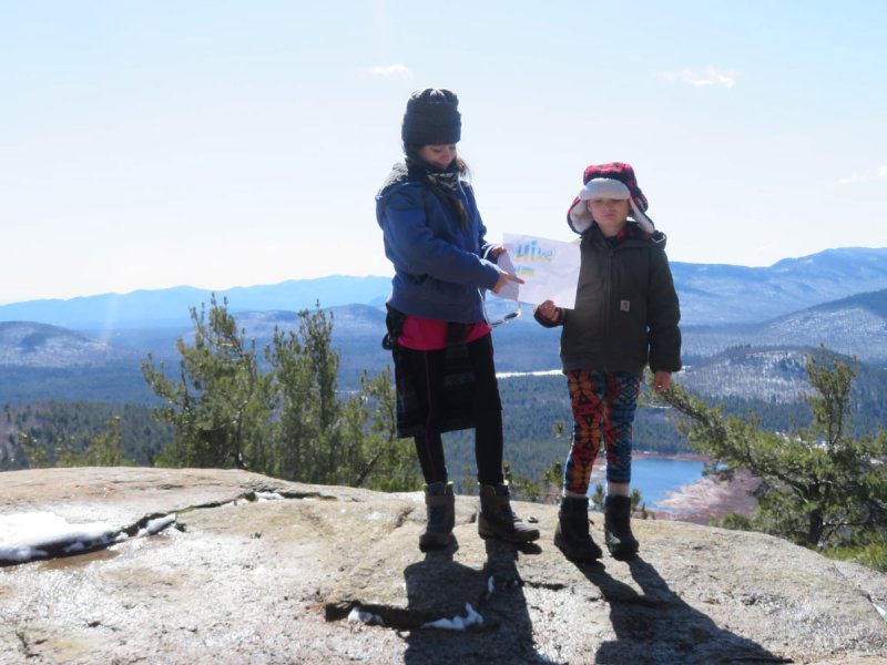 Caitlyn Rivers, 13 and Braiden Rivers, 9 proudly display their Hike for Ukraine sign atop Silver Lake Mountain, Ausable Forks. Along with their grandmother and avid ADK hiker, Marta Bolton Quilliam, they are the first to summit a mountaintop for the Hike for Ukraine Challenge. Photo provided. 