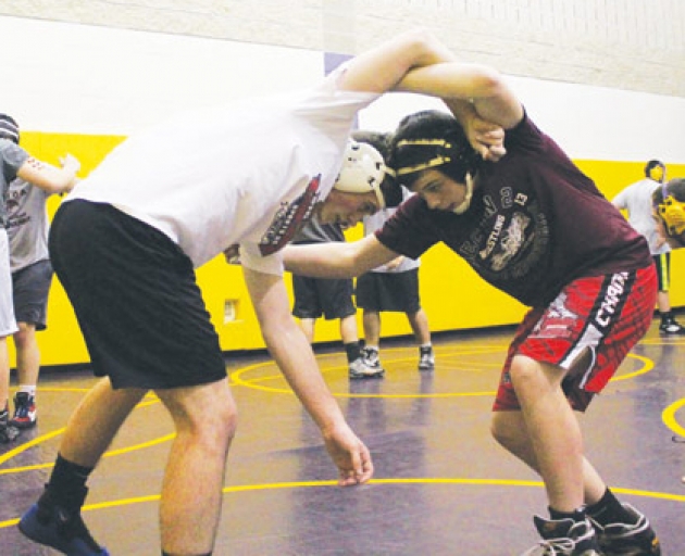 Eighth grade standout wrestler Tyler Barnes (right) practices with teammate Eric Howe, Tuesday, November 26 at Ballston Spa High School.