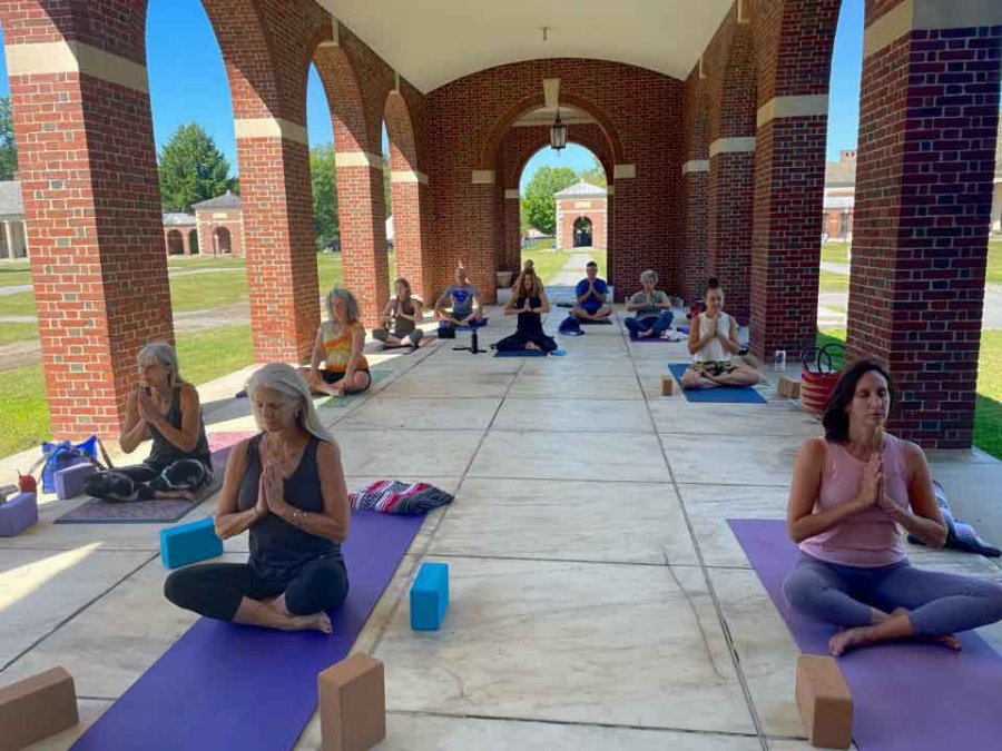 Yoga in Spa State Park is held outdoors under the brick arches of the Administration Building. Photo via the program’s Facebook page. 