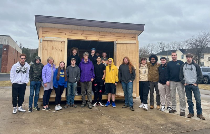 SoBro Conservancy Board Members Tom Denny and Carol Godette pose with students in front of a  student-built shed. The shed will help transform a former gas station site at 209 South Broadway in  Saratoga Springs into a green space. Photo provided by WSWHE BOCES.