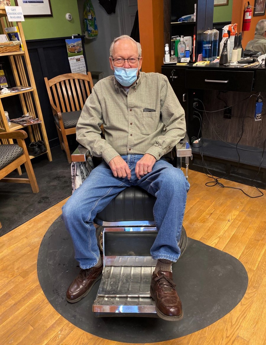 Larry Jenks poses in the barber’s chair inside Larry’s Barbershop on Washington Street on Feb. 2, 2021. He recently celebrated 50 years in the business. Photo by Thomas Dimopoulos.