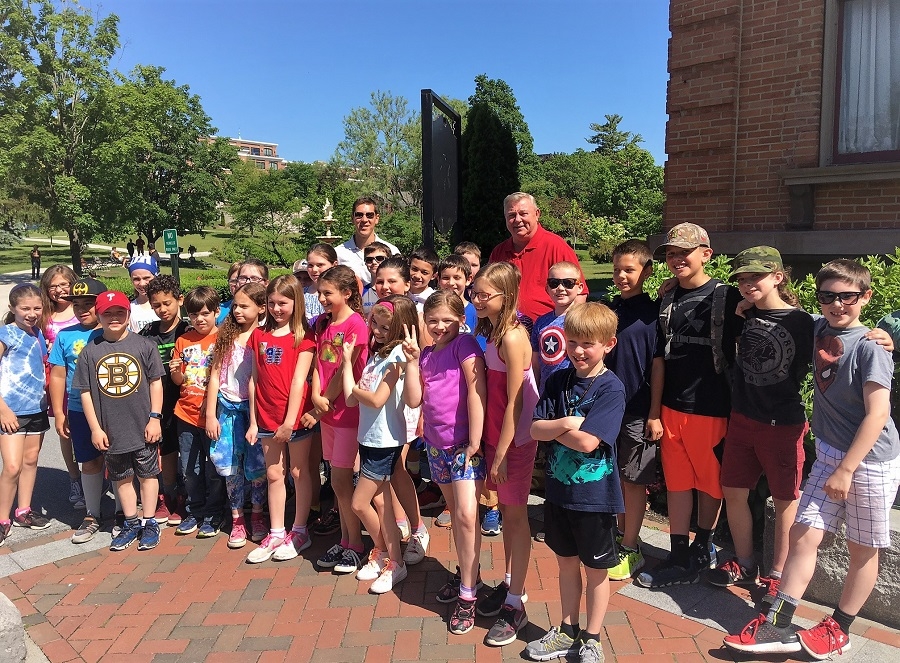 Dave Patterson, center in a red shirt, and fourth grade students from the Geyser Road Elementary School, outside the Saratoga Springs History Museum in Congress Park on June 8, 2017. 