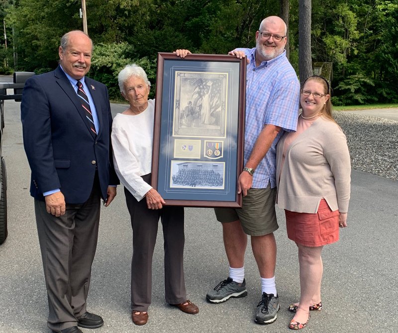 Mildred and Daniel Green, family of Corporal Beisswanger, holding Beisswanger&#039;s Wound Certificate surrounded by Tim and Heather Mabee of the Mabee Foundation, supporters of Purple Hearts Reunited. Photo provided. 