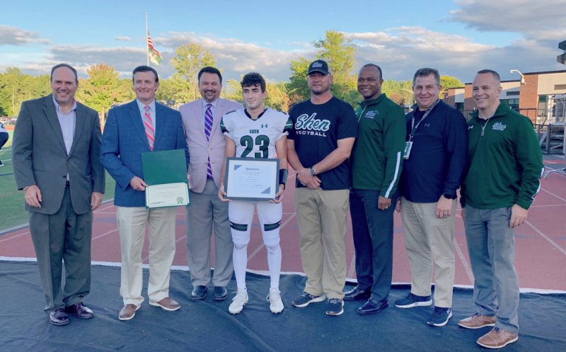 Left to right: Kevin Egan, spectrum Director of Governmental Affairs; Phil Barrett, Clifton Park Town Supervisor; Chris Watson, Spectrum News 1 Play-by-Play Announcer; Michael McElrath, Shen High School Scholar-Athlete; Brian Clawson, Shen Football Coach; Dr. Oliver Robinson, Shen CSD Superintendent; Chris Culnan, Shen Athletic Director; Ron Agostinoni, Shen High School Principal. Photo provided.