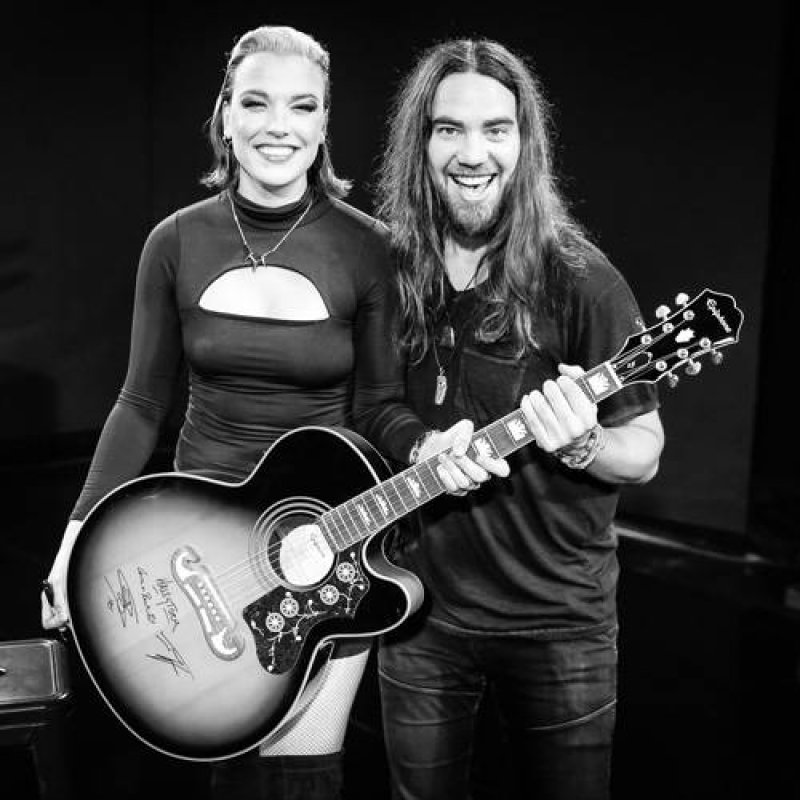  Lzzy Hale and Joe Hottinger, of the band Haelstorm, with an Epiphone guitar offered in a giveaway to celebrate the 10th anniversary of Death Wish Coffee.