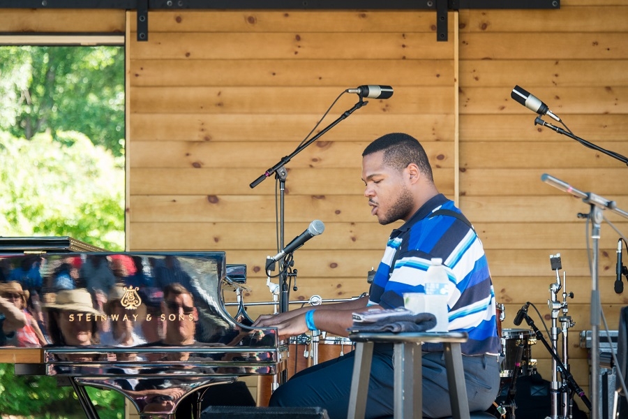 Blind Boy Paxton performing on the Steinway piano atop the Gazebo Stage at Saratoga Jazz Fest earlier this year. A multi-instrumentalist blessed with a ridiculous amount of talent as anyone fortunate enough to have caught Paxton’s set at the jazz festival will attest. 