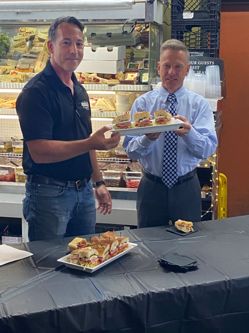 Cardona’s Market Co-Owner Robert Cardona (left) at the debut of a celebrity sandwich named “The Mig” in honor of retired Jockey and now-Saratoga Live TV Personality Richard “The Mig” Migliore (right).