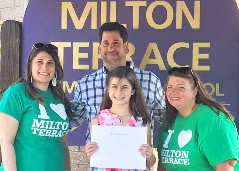 Milton Terrace Elementary School fifth grader Emma Newman receives the “Maurice ‘Christopher’ Morley Literacy Fund” Award from her teachers during the 5th Grade Moving-Up Recognition Parade. Photo provided.