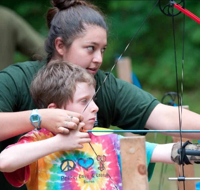 A young boy learns archery as part of the New York State  4-H Shooting Sports program. Photo via New York State 4-H.