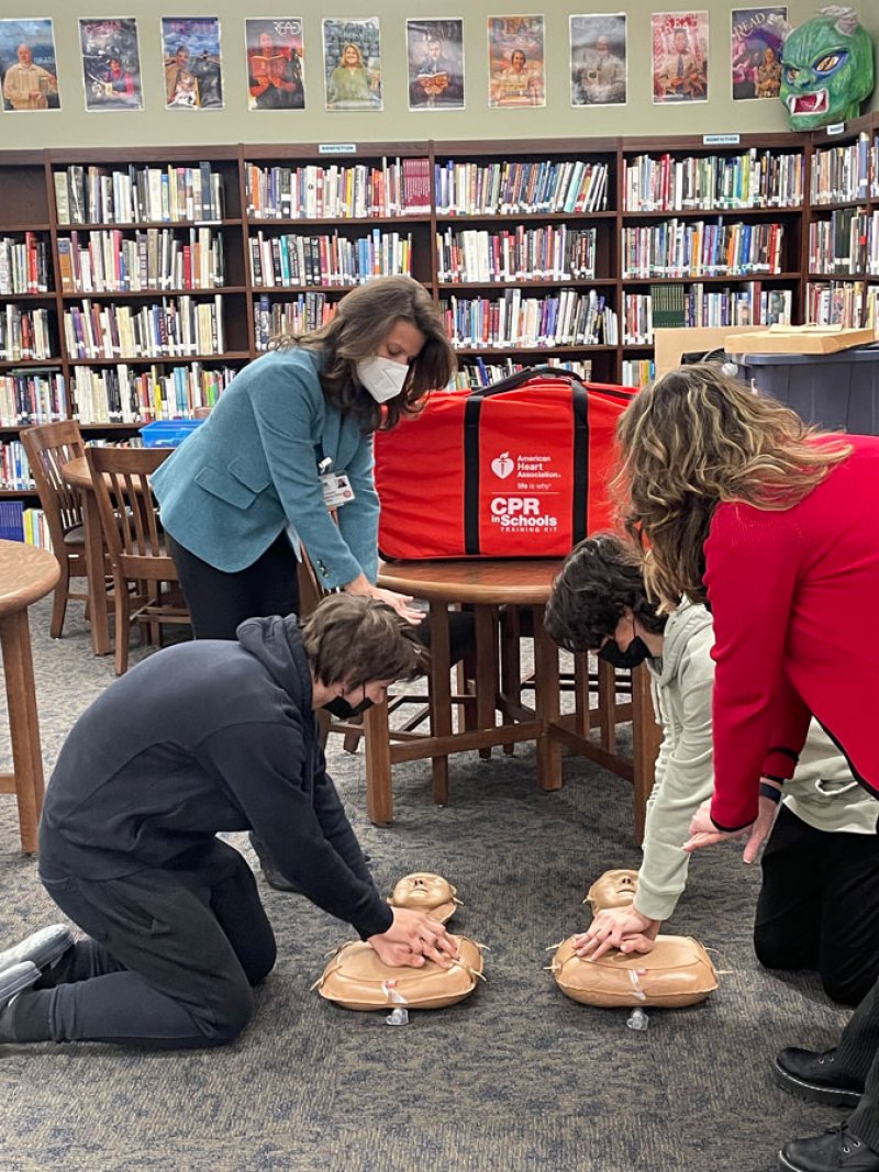 Dorothy Urschel (standing left), Chief Officer at Columbia Memorial Health, and Sharon Horton (right), teach Hands-Only CPR to Ichabod Crane students Nolan Space (left) and Dominic Pelizza.