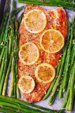Sheet-Pan Baked Rainbow Trout and Asparagus. Trout is flavored with olive oil, salt and cracked black pepper, freshly minced garlic and fresh lemon. 