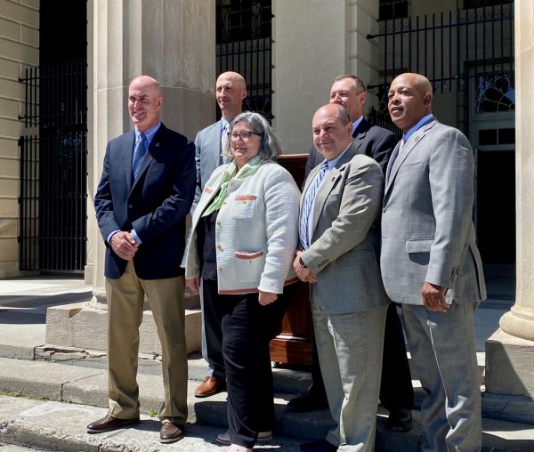 Democrat Assemblywoman Carrie Woerner flanked by members of N.Y. State Park Police from across the state on May 11, 2022 at Saratoga Spa State Park, where a press conference was staged to eliminate the existing “quasi-merger” between Parks Police and State Police, and reinstate Parks Police law enforcement leadership. Photo by Thomas Dimopoulos.
