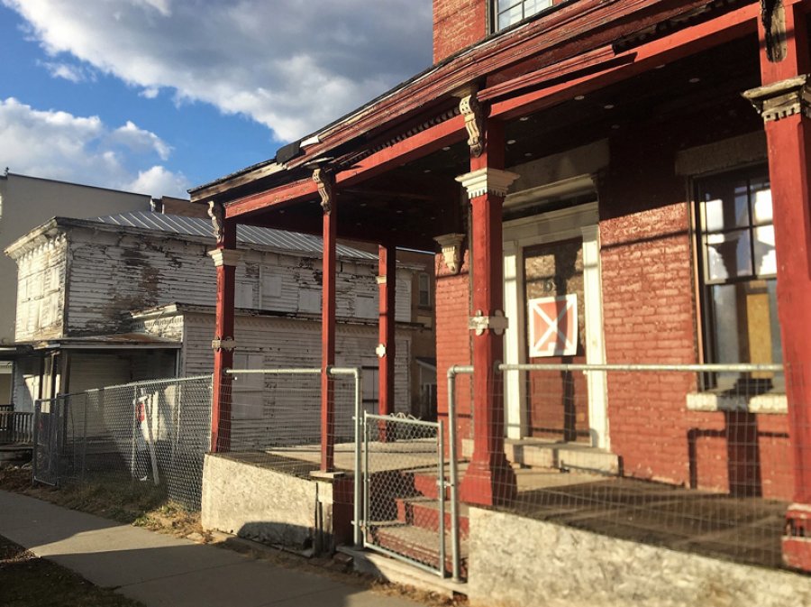 A determination of historic significance will be made regarding a pair of vacant structures at 65 Phila St. (white building at left) and 69 Phila St. (red building at right), with an eye on future demolition.  Photo Dec. 1, 2020 by Thomas Dimopoulos.  