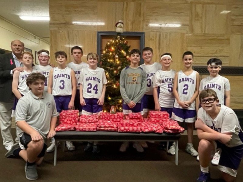 Basketball players from Spa Catholic, along with members of the Devizzio family, collected donations and bought Christmas gifts for a local family. Photo provided by Tony Devizzio