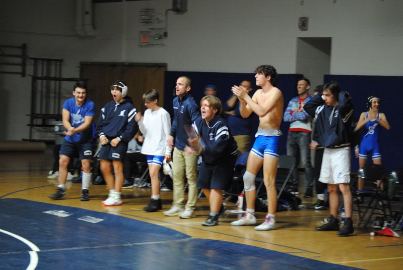 The Saratoga varsity wrestling team celebrates during the Blue Streaks’ 66-4 win over Guilderland on Dec. 21. Photo by Dylan McGlynn.