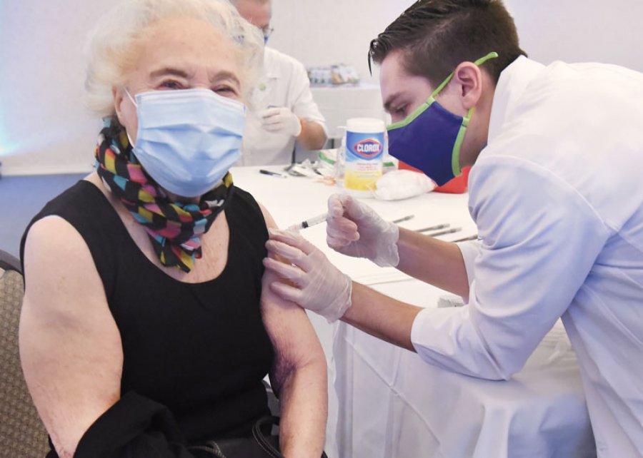 94-year-old Jo Ambrosio receives her vaccine from pharmacy intern Ben Schmidt on Jan. 27, 2020 at Prestwick Chase, a Saratoga senior independent living community. Photo by SuperSource Media. 