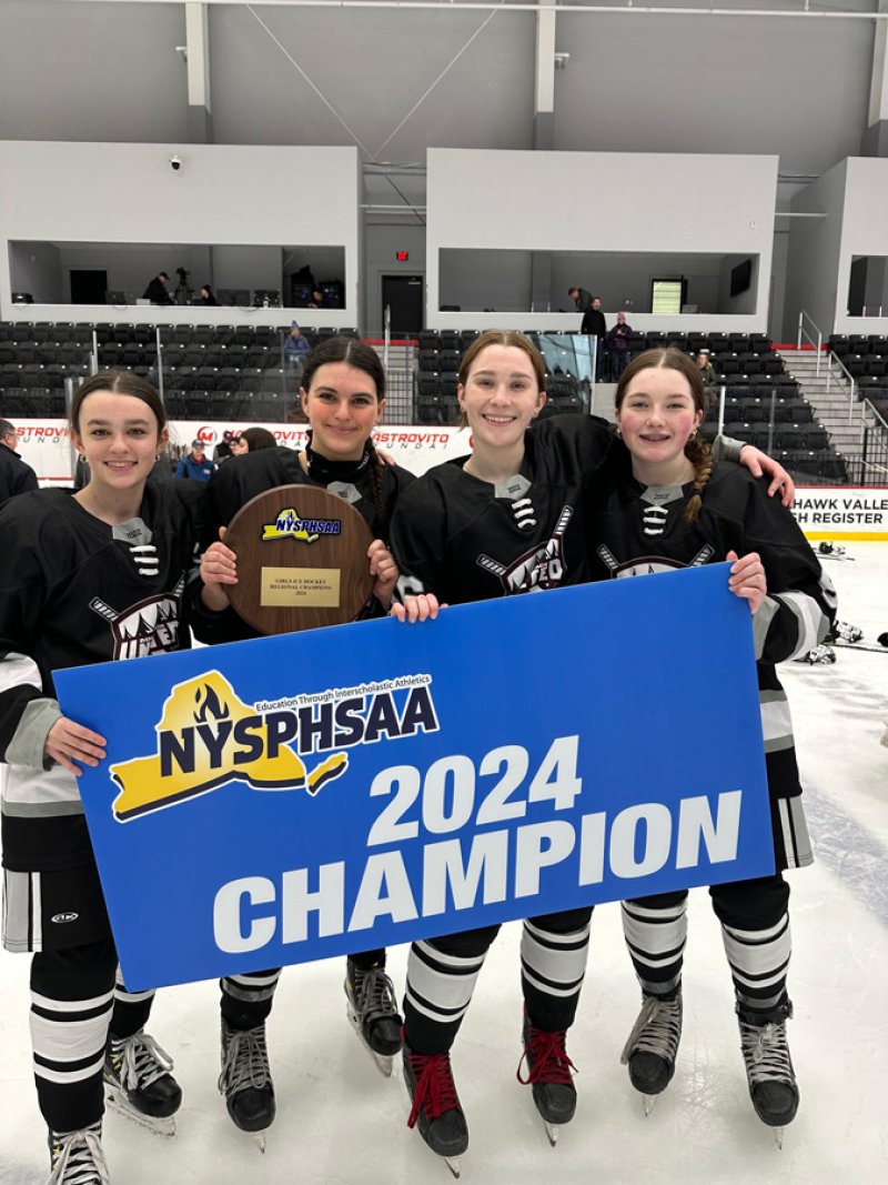 The Adirondack United girls’ hockey team celebrates its NYSPHSAA regional championship victory. Photo via Saratoga Athletics.