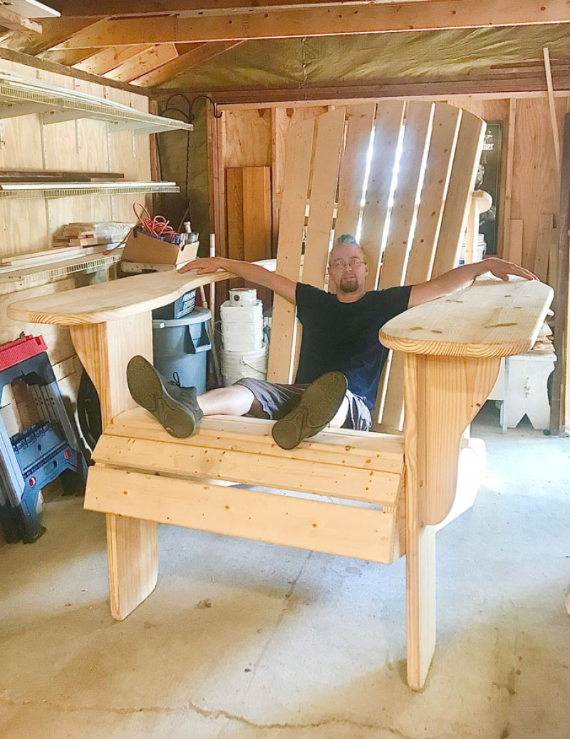 Artist Anthony Richichi and the soon to-be-painted Adirondack chair.  Photo provided.