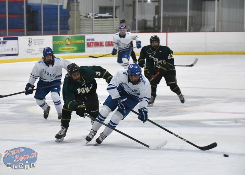 Toga battles on the ice against opponents in a game earlier this season