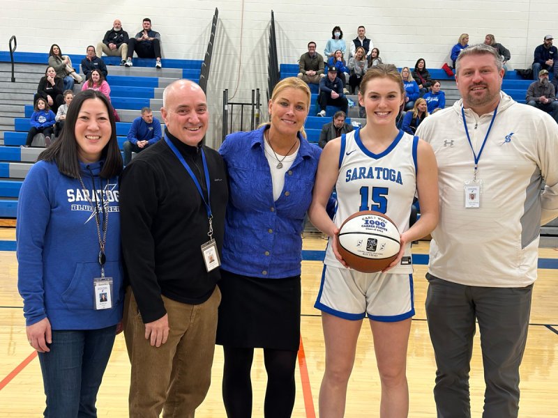 Saratoga Springs High School girls basketball player Carly Wise celebrates her 1,000th career point with a custom-made basketball.  Photos via the Saratoga Athletics X account. 