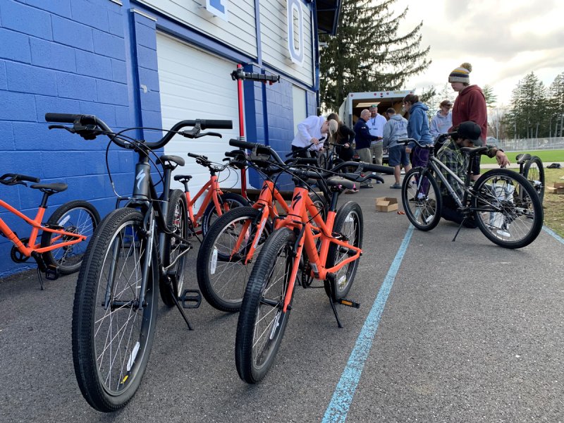 A team comprised of Saratoga Shredders members and the Saratoga Springs City School District’s physical education staff builds 30 bikes in the East Side Recreation Park as part of a new Bikes in Schools program. Photo by Jonathon Norcross. 