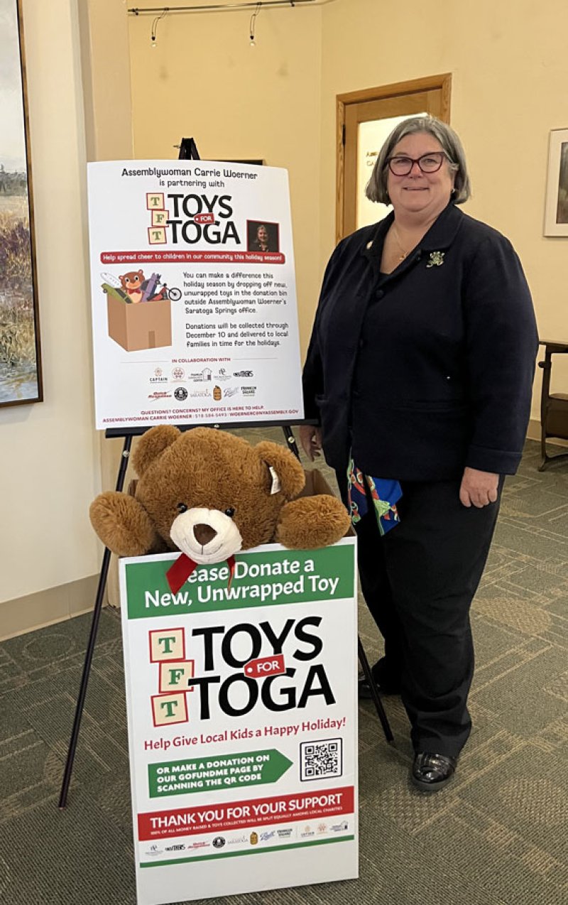 Assemblywoman Carrie Woerner poses outside her office at 112 Spring St., where toys for children will be accepted. Photo provided.