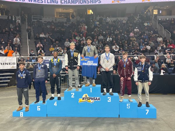 Taylor Beaury (far right) stands at the podium after finishing in seventh  place in the 126-pound weight class at the 2023 NYSPHSAA Division 1 wrestling championships. Photo provided by Jake Zanetti.