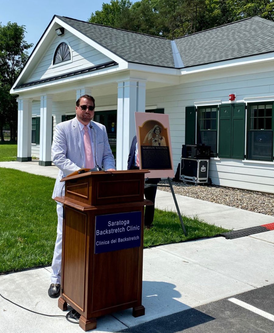 Philanthropist John Hendrickson speaking just prior to a ceremonial  ribbon-cutting to commemorate opening of Saratoga Backstretch Clinic at Saratoga Race Course on July 11, 2023. Photo by Thomas Dimopoulos.