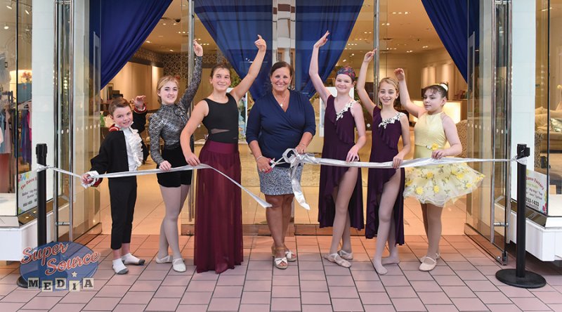 Dianne Sporko-Carola cuts the ribbon during The Dance Factory’s grand opening with help from some of her dancers. Photo by Super Source Media.