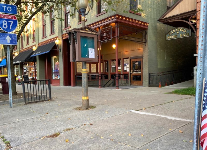 A vacant patch of Broadway sidewalk between Saratoga Music Hall and the Collamer Building – the lower level of which is where Matt McCabe operated Saratoga Guitar – may soon serve as a commemoration site to honor the former finance commissioner. Photo by Thomas Dimopoulos. 