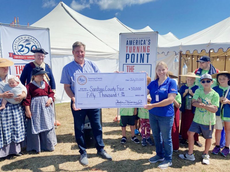 Chairman and Town of Moreau Supervisor, Theodore J. Kusnierz, Jr. Presents a check for $50,000 to Jennifer Flinton, President of the Saratoga County Fair. Photo provided.