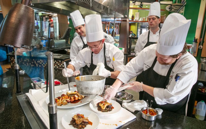 The Skidmore College dining team — including manager Michael Hinrichs (center left) and cooks Matt Palmer (left), Pat Ives (center right), and Chris McGilpin (right) — competes in the 10th annual American Culinary Federation Conference and Competition.  Photo via Skidmore College.
